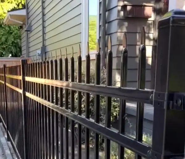 Black ornamental metal fence installation with spear top design in Seattle