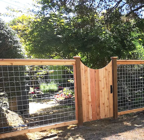 Wood and hog wire fence with custom wooden gate installed in Seattle backyard