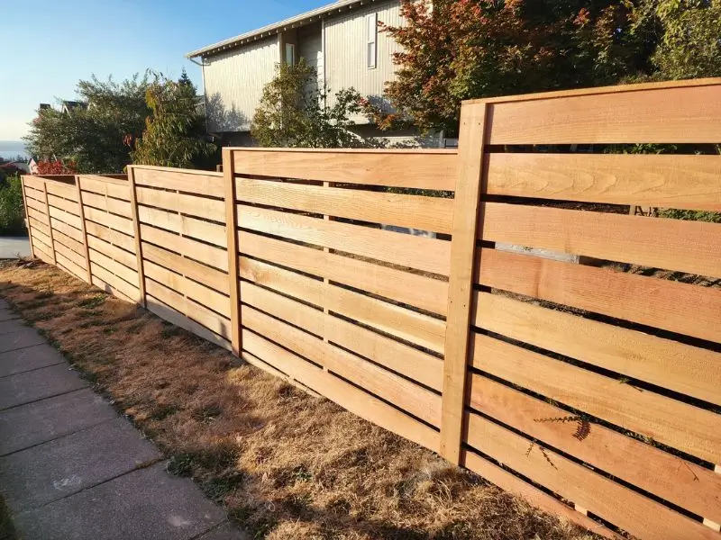 Modern horizontal wood fence installation for backyard privacy in Seattle<br />
