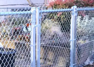 Chain link fence installation with metal gate in Seattle residential property