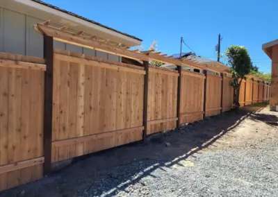 Custom wood fence with decorative pergola top installed in Seattle residential property