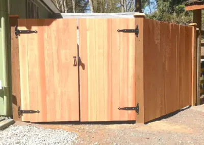 Double wood gate installation in Seattle with black metal hardware