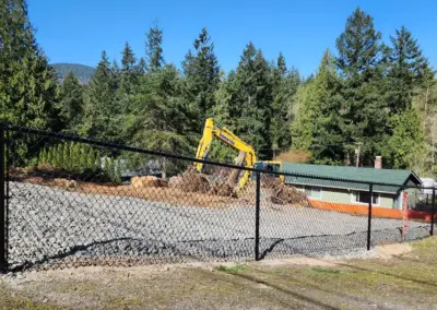 Black chain link fence installed on a residential property during site preparation