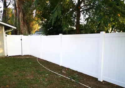 White vinyl privacy fence installation in Seattle backyard