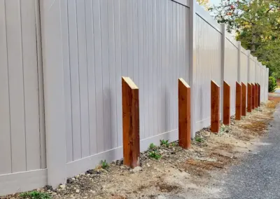 Vinyl fence installation with reinforced posts along driveway in Seattle