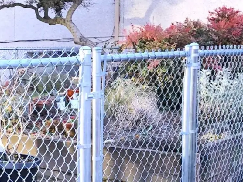 Chain link fence gate installed in a residential yard<br />
